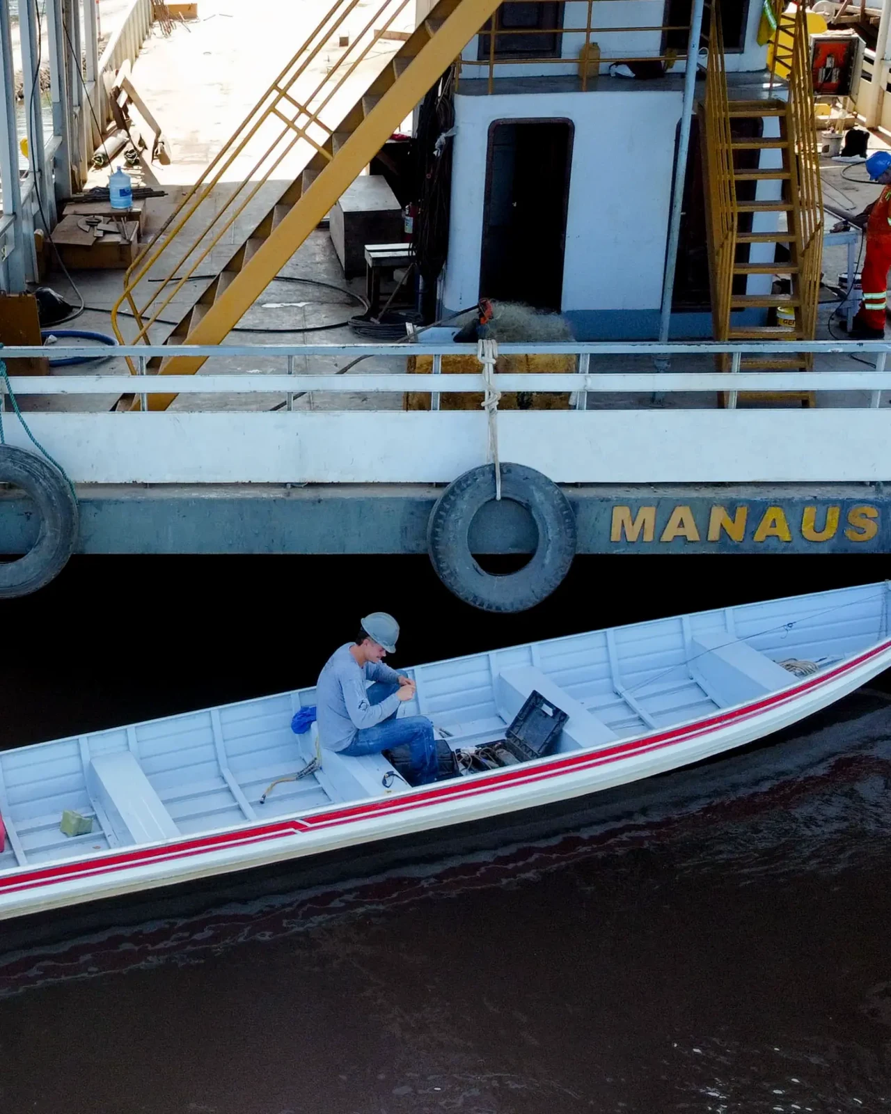 Professional with a computer aboard the Manaus support vessel